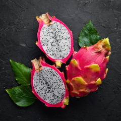 Fresh Pytahya on a black background. Dragon Fruit. Tropical Fruits. Top view. Free space for text.