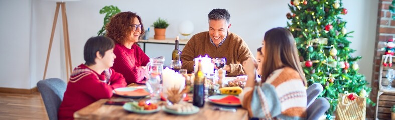 Beautiful family smiling happy and confident. Eating roasted turkey celebrating christmas at home