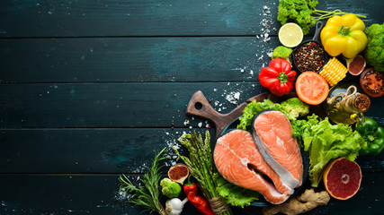 Fresh salmon fillet with vegetables. Healthy eating concept. Top view. Free copy space.