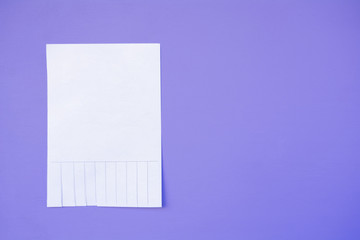 sheet of paper on a purple background, space for text, advertising, concept