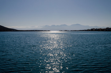surface of sea water, sun glare on the sea surface on a warm summer day