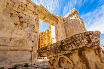 Ancient Roman temple of Bacchus and remain of one of its pillar with blue sky in the background,...