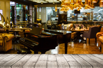 Image of wooden table in front of abstract blurred restaurant lights background.