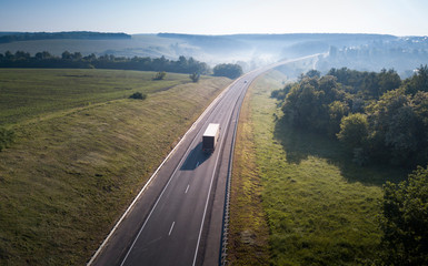 Aerial Top View of White Truck with Cargo Semi Trailer Moving on Road in Direction