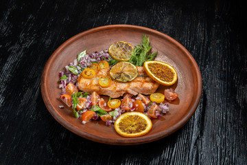 Grilled salmon and vegetables. Laid on a beautiful clay plate, sprinkled with onions, dill and tomatoes-2.