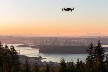 Obraz na płótnie Canvas A small consumer drone overlooking the city of Vancouver.