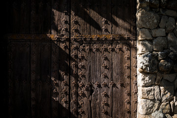 Old wooden and iron door in the medieval village of Guadalest, on of the most beautiful village of Spain - Alicante