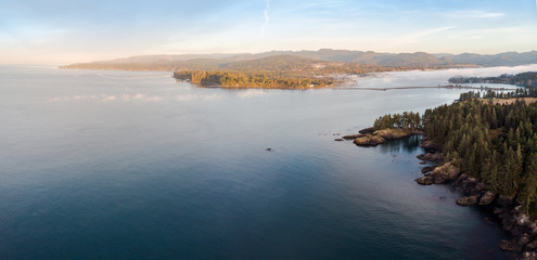 Aerial view of a bank of sea fog moving down a bay over a the rugged Vancouver Island coastline.