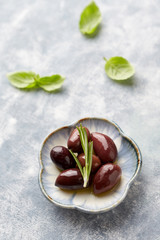 Kalamata olives on bright wooden background. Close up. 