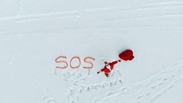 SOS-signal of Santa Claus in snow wides