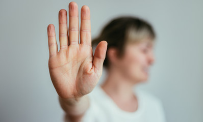 Obraz na płótnie Canvas Defense or stop gesture: Girl hand with stop gesture
