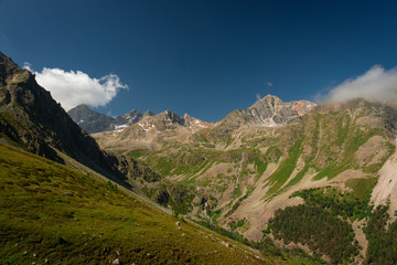 Mountain gorge Goralikol with peaks of a mountain range in the Teberdinsky nature reserve summer with green slopes