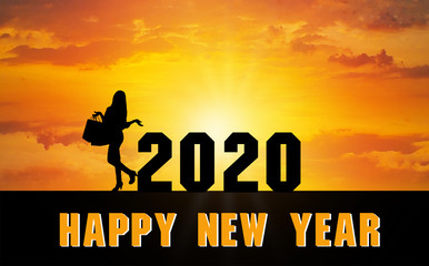 Happy New Year 2020 Silhouette. A girl holding a shopping bag standing beside the numbers 2020 Sunset time