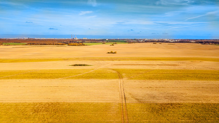 Fototapeta premium View from the field to the town in the autumn