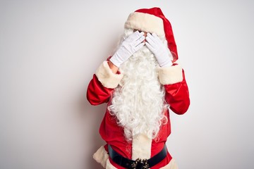 Middle age handsome man wearing Santa costume standing over isolated white background rubbing eyes for fatigue and headache, sleepy and tired expression. Vision problem