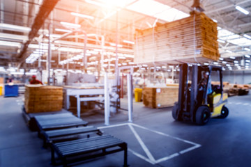 Bloored background of forklift loader in storage warehouse ship yard. Distribution products. Delivery. Logistics. Transportation.