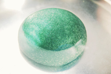 Light green konjac sponge in water. Facial massage and exfoliating beauty accessory.