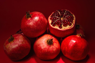 Sweet pomegranate on red background.