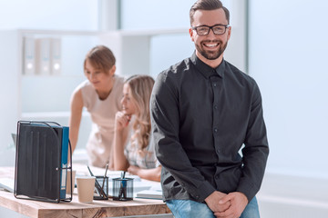 smiling young business man standing in office