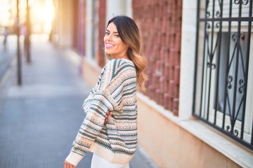 Fototapeta premium Young beautiful woman smiling happy and confident. Standing and walking at town street