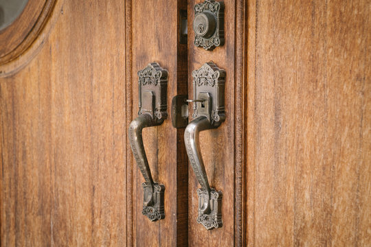 old metal - iron, handle on a wooden door.