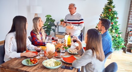 Beautiful family meeting smiling happy and confident. Speaking speech eating roasted turkey celebrating Christmas at home