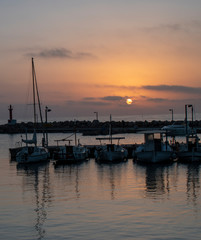 Fototapeta na wymiar Colourful and Golden Sunrise over Cala Bona Marina Majorca.