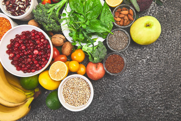 Alkaline diet food, Clean eating. Healthy vegetarian seasonal, fall food cooking background. Flat lay of Autumn vegetables and herb over grey concrete background, top view, copy space.