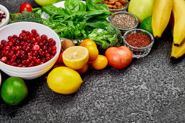 Healthy food background, trendy Alkaline diet products - fruits, vegetables, cereals, nuts, oils, dark grey concrete background. Free for trext. Top view..