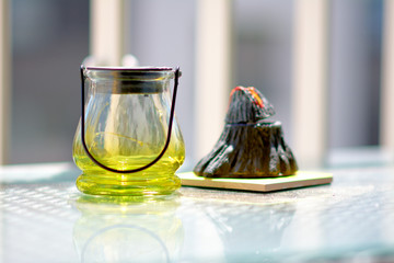 Lamp with aromatic oils on a glass table.