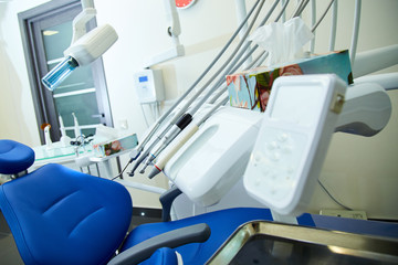 Modern metallic dentist tools and burnishers on a dentist chair in Dentist Clinic. Different dental instruments and tools in a dentists office.