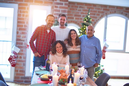 Beautiful family smiling happy and confident. Standing and posing with tree celebrating Christmas at home