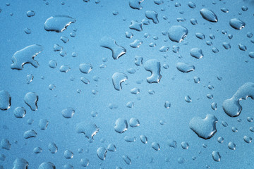 rain drops are spreaded on a meatllic surface for background 