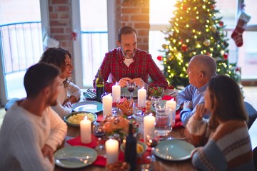 Beautiful family smiling happy and confident. Eating roasted turkey celebrating Christmas at home