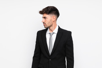 Young businessman over isolated white background looking side
