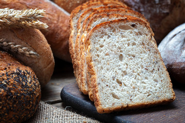 pile of fresh baked bread on wooden table