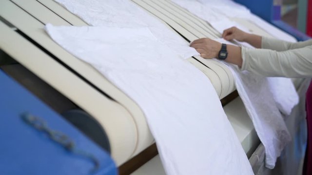 Video of industrial washed laundry ironing machine for big amount of textiles