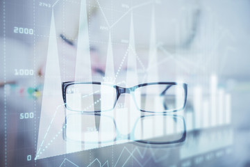 Hand taking notes in notepad. Forex chart holograms in front. Concept of research. Double exposure