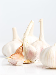 A few heads of garlic on a white background.