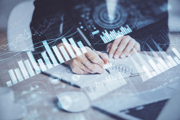 Forex graph on hand taking notes background. Concept of research. Multi exposure
