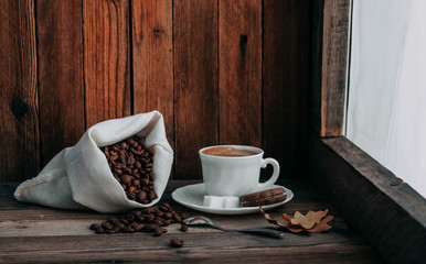 coffee Cup with beans on wooden background