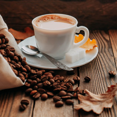 coffee Cup with beans on wooden background