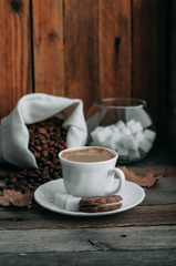 coffee Cup with beans on wooden background