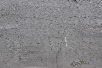 a cracked white stucco wall