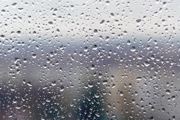 Raindrops on window glass surface, background texture