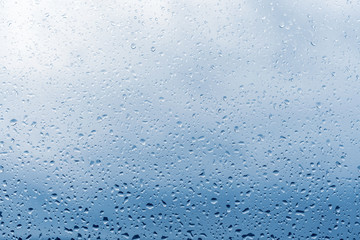 Raindrops on window glass surface, background texture