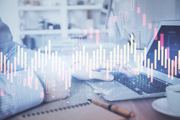 Multi exposure of stock market chart with man working on computer on background. Concept of financial analysis.