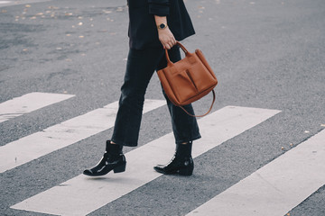 fashion blogger autumn 2019 outfit details. fashionable woman wearing black jeans, black ankle...