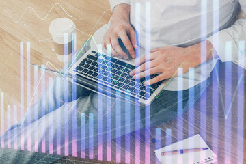 Forex graph with businessman working on computer in office on background. Concept of analysis....