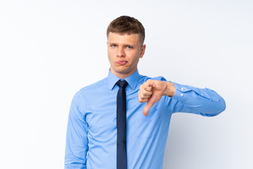 Young handsome businessman showing thumb down sign